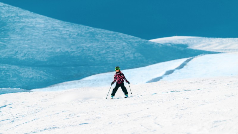 boy skiing down mountain
