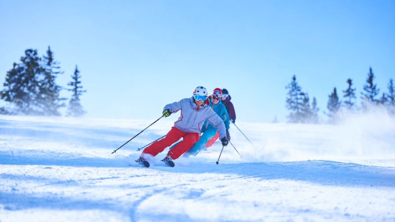 group of skiers headed downhill