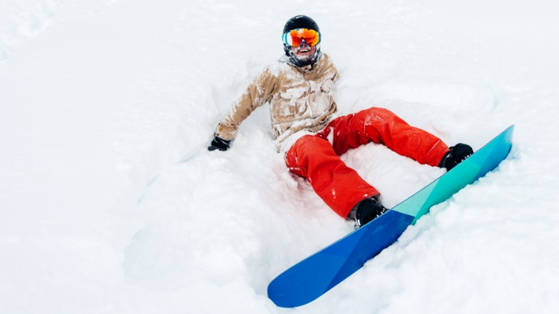 Snowboarder sitting in the snow