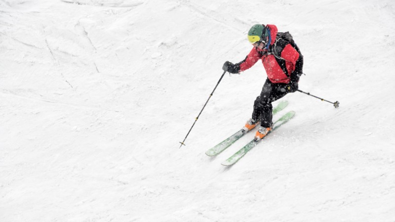 Man slowly skiing down a mountain