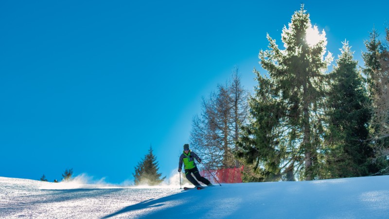 Woman skiing down a steep mountain