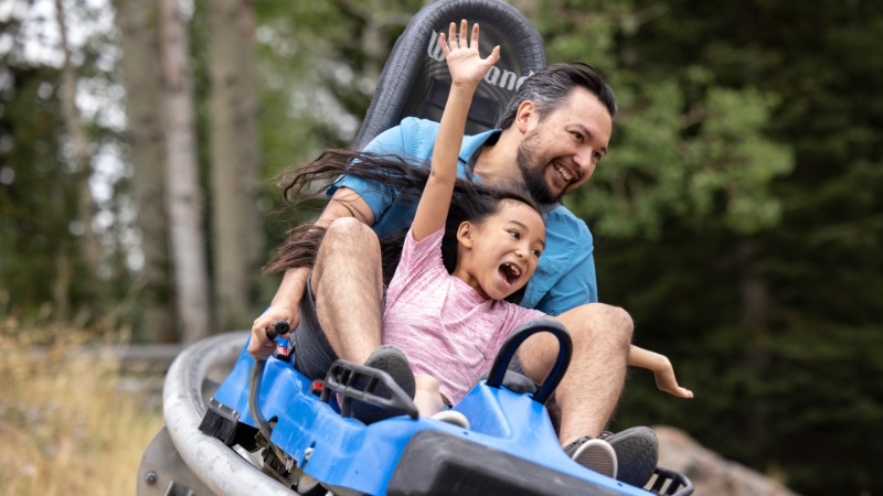 Family sliding down the mountain coaster