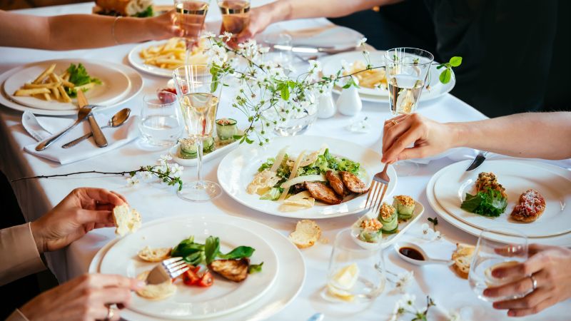 a group of people having lunch or dinner at a restaurant